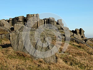 Large rugged gritstone outcrop at the bridestones a large rock formation in west yorkshire near todmordenwith blue sky and