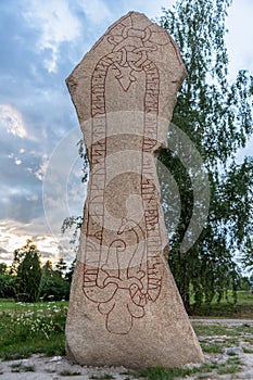 Large rune stone with runes in the shape of a long red snake