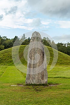 Large rune stone standing at an ancient burial ground