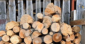 Large rural stack of firewood. Old firewood. Background