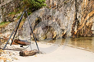 Large rusty fire pit or BBQ on beach in Norwegian fjord