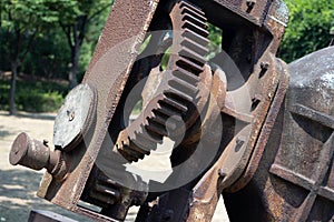 Large rusty gear attached to the water supply control valve