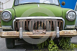 Large rusty green car