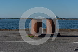 Large rusty iron bollards at a dock