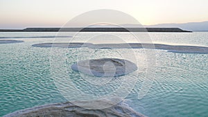 Large Salt accumulated on the shore of the Dead sea. Deposits of mineral salts, typical landscape of the Dead Sea. Salt on beach