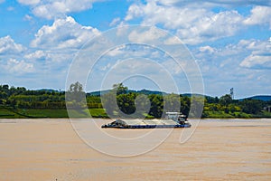 Large sand mining boat driving on the river outdoors