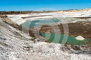 Large sand pit and lake. A flooded old abandoned quarry complex. Extraction of sand and stone for industrial applications