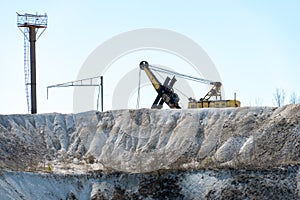 Large sand quarry. An old excavator on top of a hill. Extraction of sand and stone for industrial applications