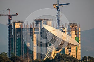 Large satellite dish on the building onstruction background