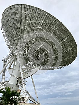 Large satellite dish with cloudy sky for telecommunications and broadcasting in Thailand