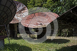 Large satellite dishes abandoned in a garden in the Philippines