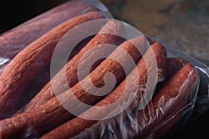 Large Sausages close-up in Vacuum Bag. Place for label. Ready-made Meat Products for Supermarket