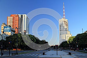 A large scale depiction of Eva Peron adorns the side of a large edifice along the Avenida 9 de Julio