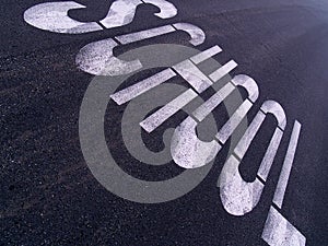 Large SCHOOL sign painted on an urban street