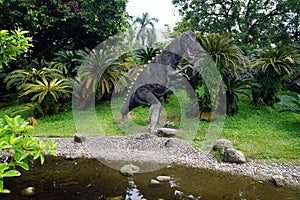 Large sculpture of a tyrannosaurus rex dinosaur in the garden