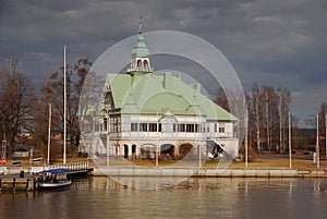 A large seaside house with traditional Finnish architecture with green roof