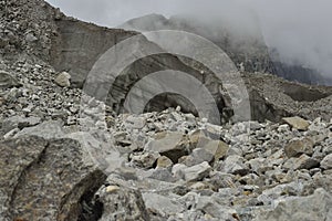 Large section from Khumbu glacier with layers made by ice, rocks, mud, small vegetation. Nepal.