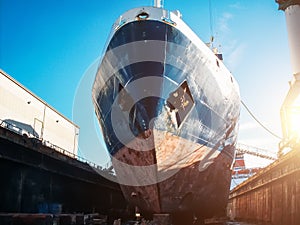 Large seismic or cargo ship in dock on harbor for repair and maintenance, Industrial nautical vessel boat in dockyard