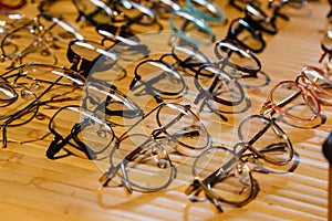 Large selection of sunglasses and glasses on a stand