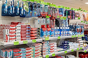 Large selection of toothpastes, brushes and oral care products on shelves in supermarket. Minsk, Belarus, 2022