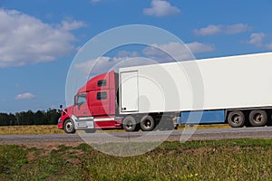 Large semi-trailer moves on a country road