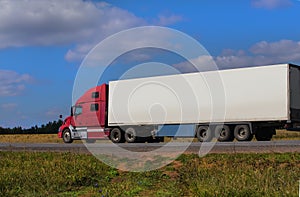 Large semi-trailer moves on a country road