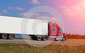 Large semi-trailer moves on a country road