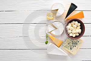 A large set of cheeses. Mozzarella, blue cheese, brie cheese, maasdam.