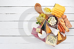 A large set of cheeses. Mozzarella, blue cheese, brie cheese, maasdam.