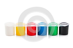 Large set of gouache paint cans in a row. Colorful paints isolated on white