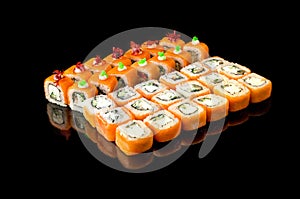 large set of Japanese rolls on a black background. Salmon  tuna  smoked eel. Close-up  top view. Food delivery concept