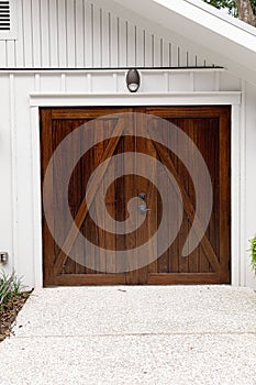 a large set of stained dark wood garage door on a public building