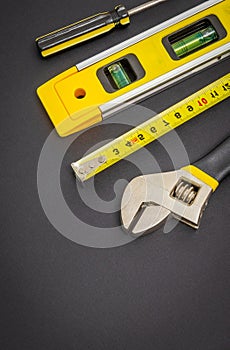 Large set of tools on black background prepared by the master before repair or construction