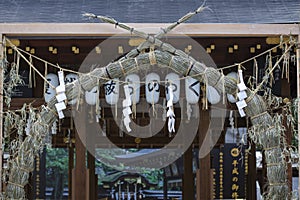 Large Shimenawa and paper lanterns at shrine entrance