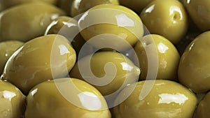 Large shiny green olives macro background