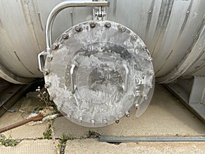 Large shiny iron metal round manhole cover with bolts and nuts for shell and tube heat exchanger or industrial stainless steel