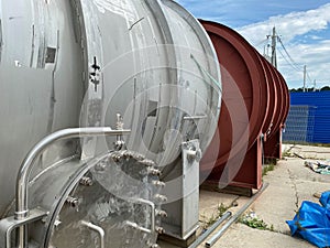 Large shiny stainless steel shell and tube heat exchanger for heating liquids and gases, ready to be installed for oil refinery