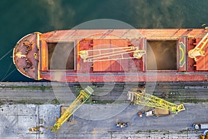 A large ship loading grain for export. Water transport