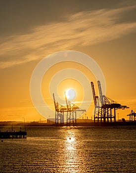 Large ship to shore container cranes at sunset