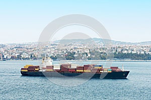 A large ship transporting numerous cargo containers through istanbul Bay, Turkey