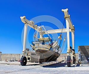 Large Ship Under Repair. A Ship in the Port, a Crane Working on the Assembly of the Ship