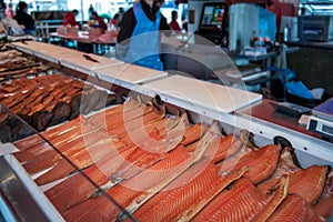 Large showcase with halves of delicious fish of the North sea trout, salmon, pink salmon on the counter in the Norwegian fish mark