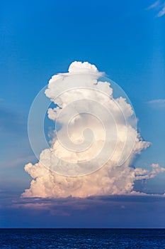 Large single cloud in a blue sky.