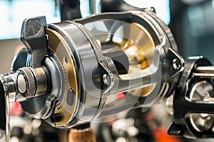 Large size fishing multiplier reel on the counter in a fishing store