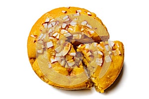 A large-sized ripe palmyra palm fruit cake sprinkled with coconut pieces.