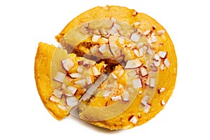 A large-sized ripe palmyra palm fruit cake sprinkled with coconut pieces.