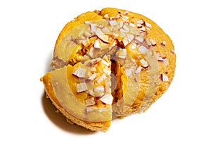 A large-sized ripe palmyra palm fruit cake sprinkled with coconut pieces.