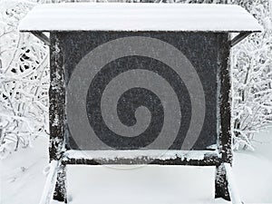 large slate board for text against the snow-covered forest in the Taganay Nature Reserve in the Urals, Russia