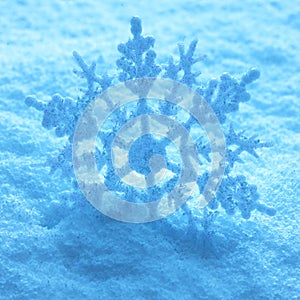 Large snowflake on snow