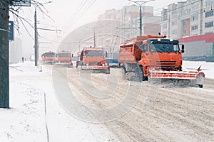 A large snowplow removes snow from the road